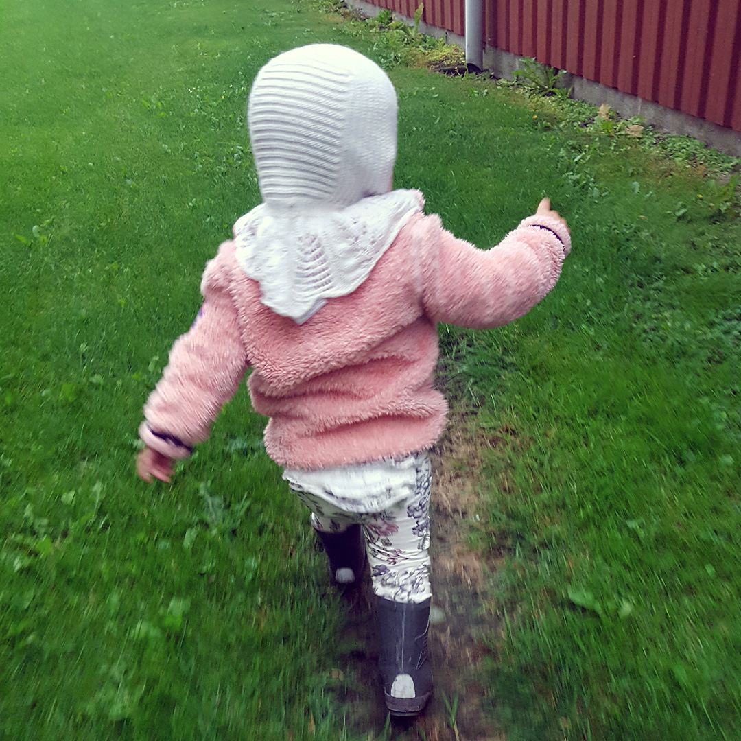 Billedet forestiller en lille pige i gummistøvler fra ryggen hos Marie Marolle privat pasningsordning